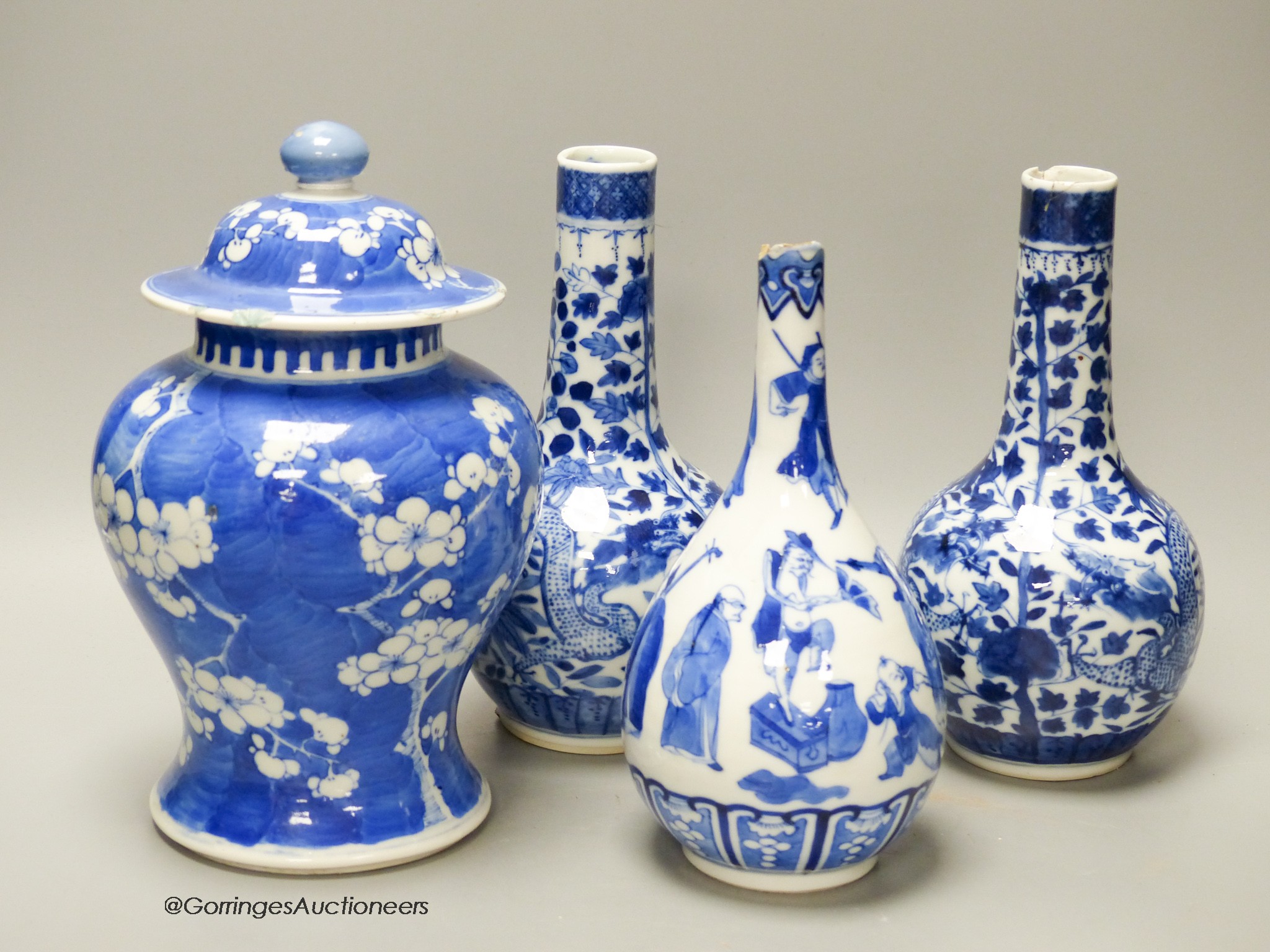 A pair of Chinese blue and white 'dragon' bottle vases, a prunus jar and cover, all late 19th century